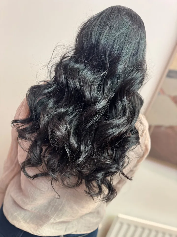 Deep brunette with full, glossy curls