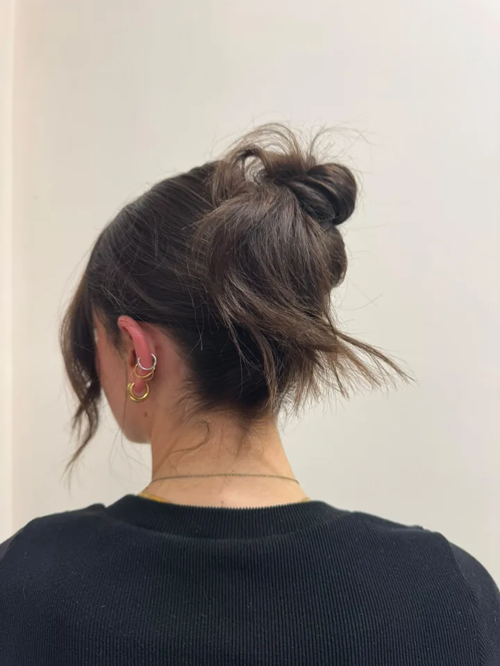 Dark brunette hair in a textured high bun